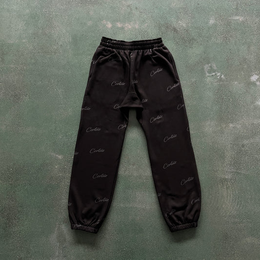 Corteiz All Over Print Joggers – Black